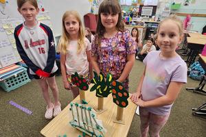 Reagan Houy, Lilly McGuirk, Sammie Younger, and Joy Dixon with their model fence windbreak