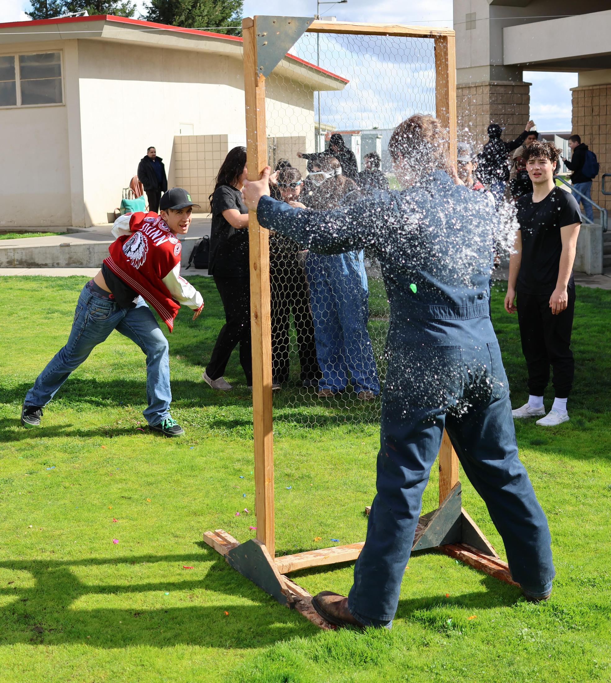 students and staff enjoying the water balloon toss