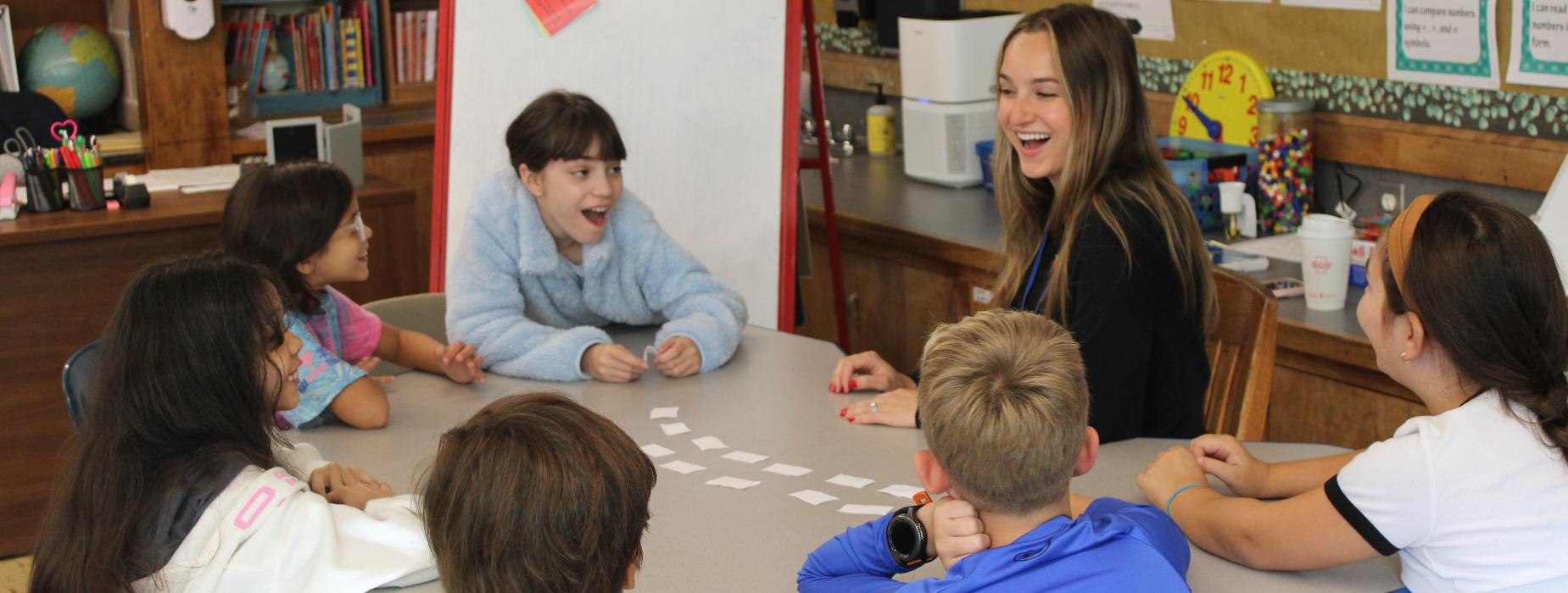 Peters fourth grade students work with Jolie Cavalloro in a small group.