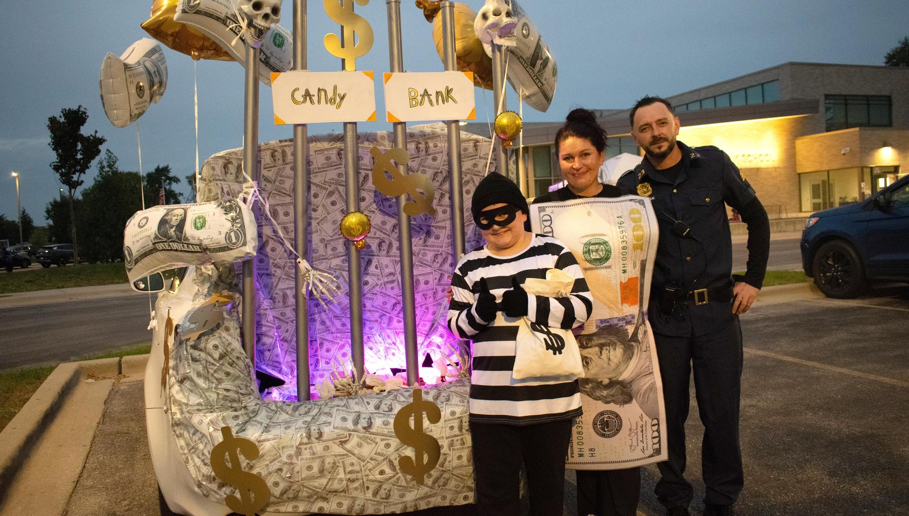 A whimsical candy bank display with a robber and police officer posing.
