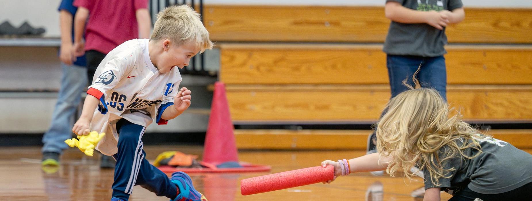 young students playing a game in phys ed class