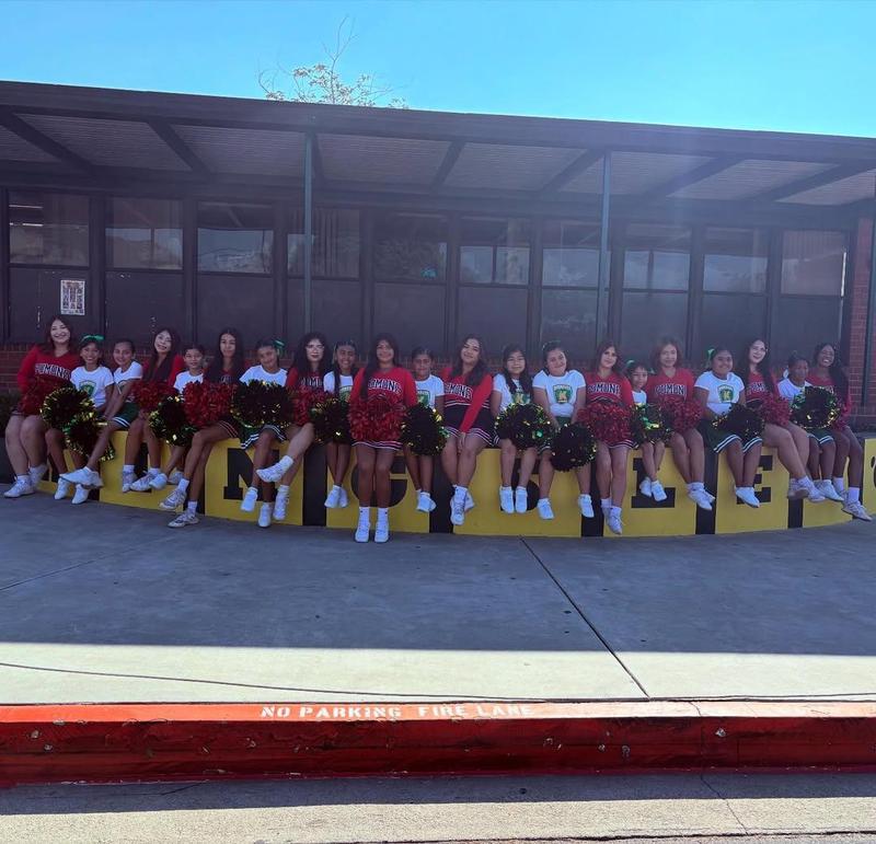 Pomona high cheerleaders pose on the KINGSLEY wall with students