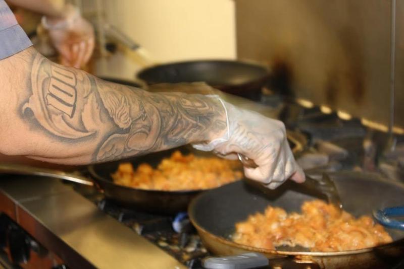 hand holding pan over fire