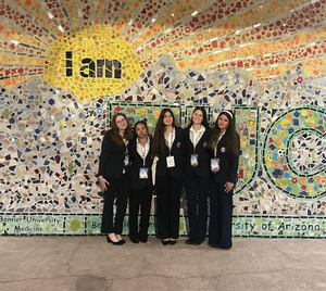photo of students in front of a mural