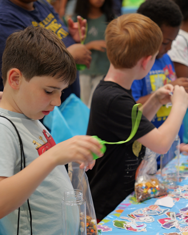 Students play with crafts at table