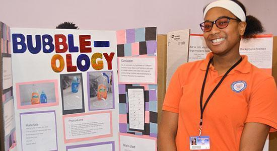 Student and teacher discussing a science fair project