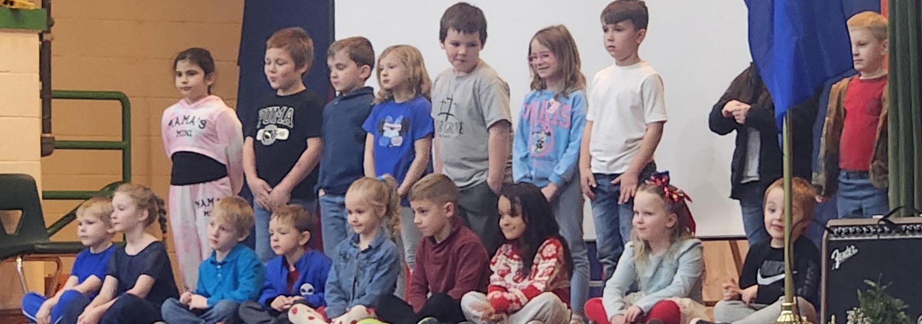 Kindergarten and First Grade students on stage ready to sing for the Veterans' Assembly.