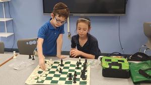 2 boys play chess against each other
