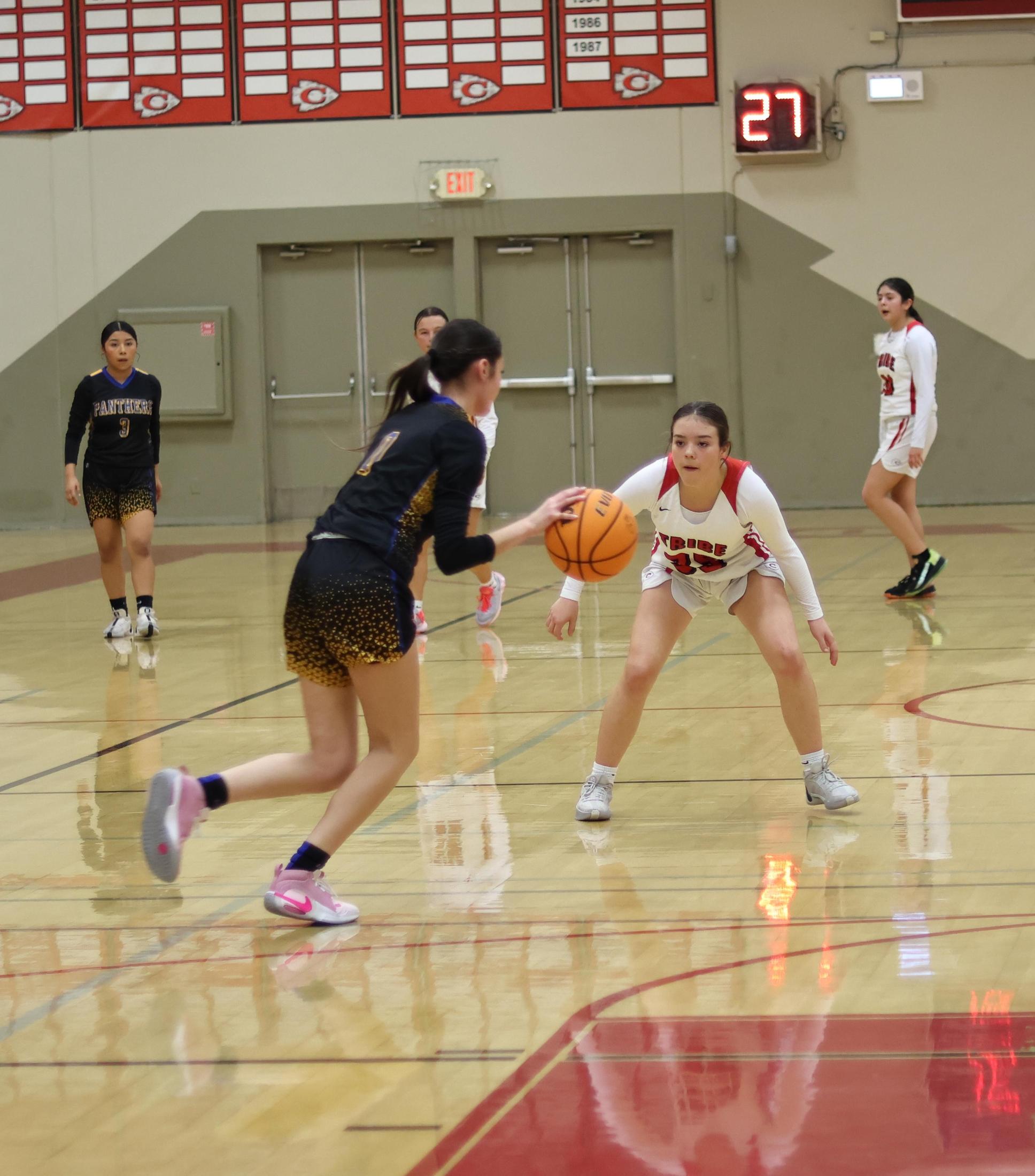 junior varsity girls playing basketball against parlier