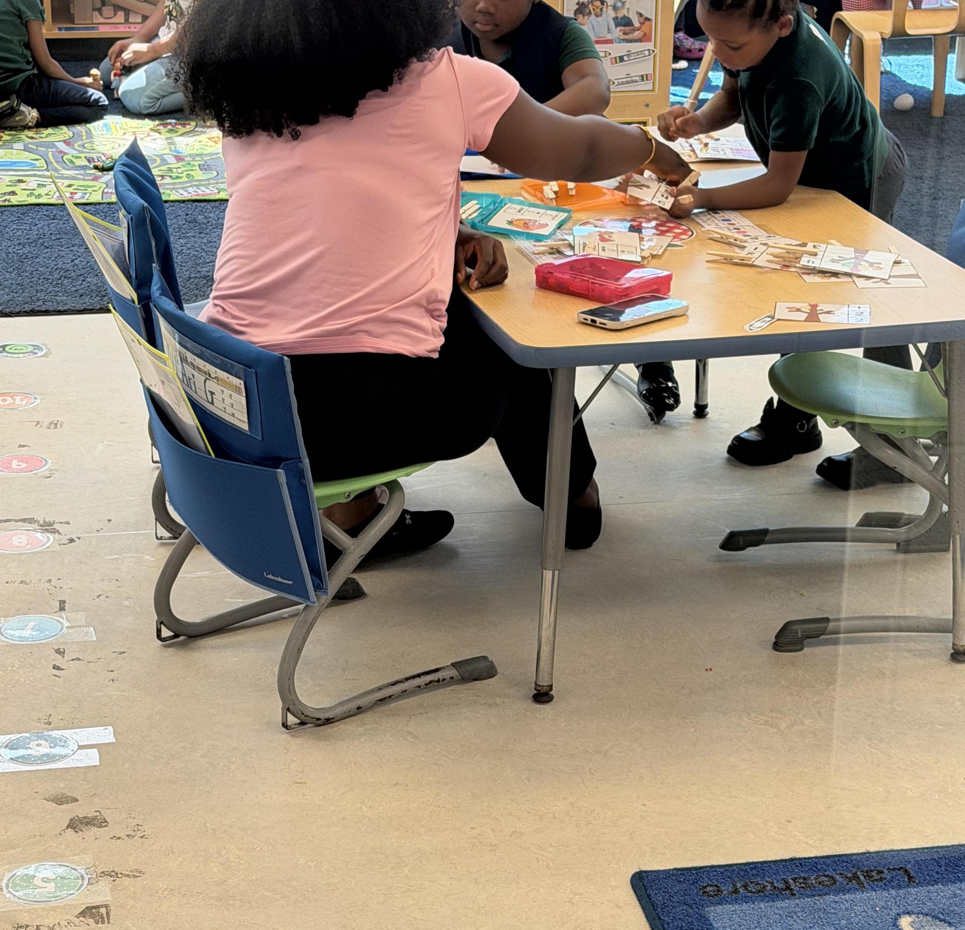 Students engaged in an educational activity at a classroom table.