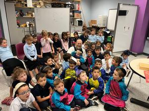 The kitah K students watch intently as the honey dipper is made.