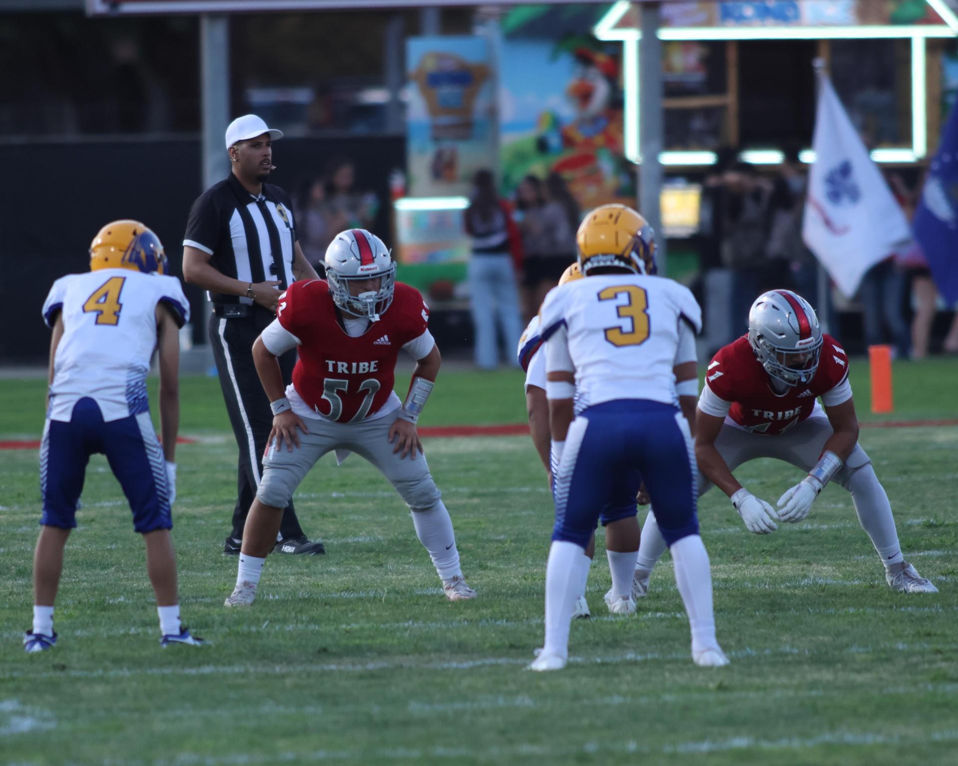 Varsity football players in action against Parlier 135