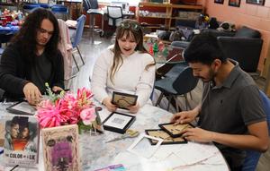 Holloway students frame QR codes for a school project