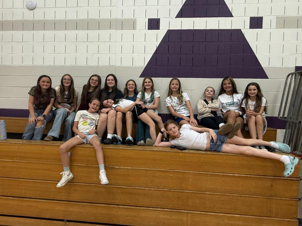A group of students in the bleachers in the gym.