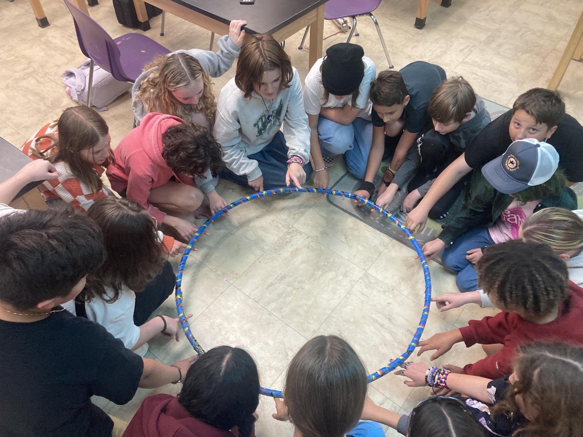 Students in classroom doing the Helium Hoop experiment