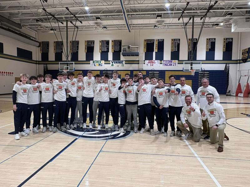 boys basketball team wearing section champ shirts