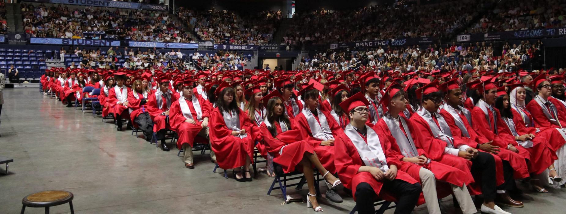 CHSW graduates sitting at graduation listening to speeches.