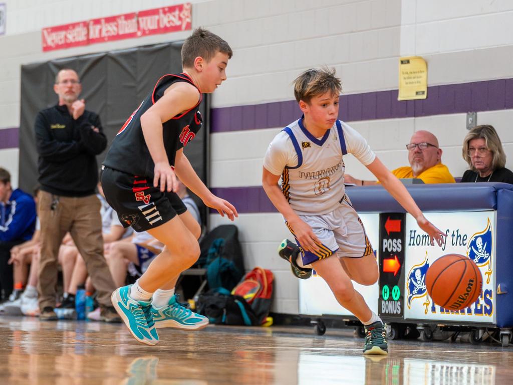 A basketball player dribbling a ball on the court during a game.