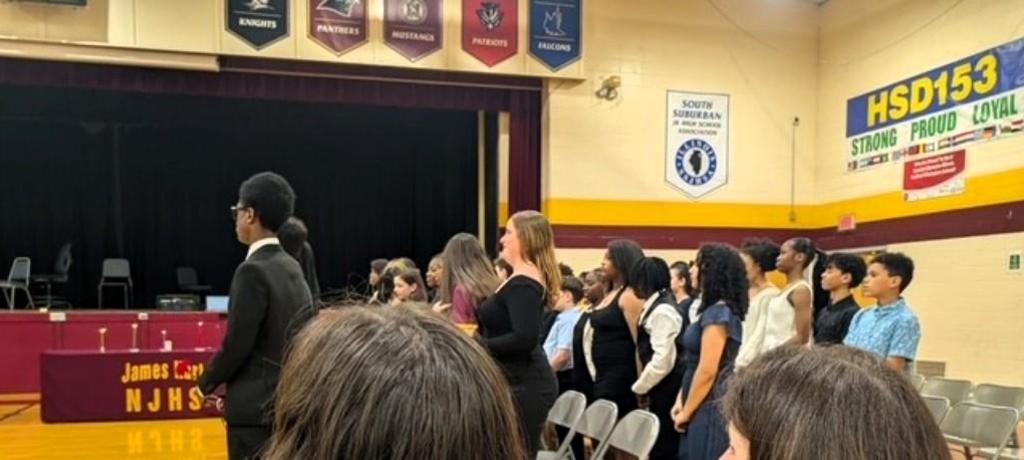 students stand in rows waiting for ceremony to begin
