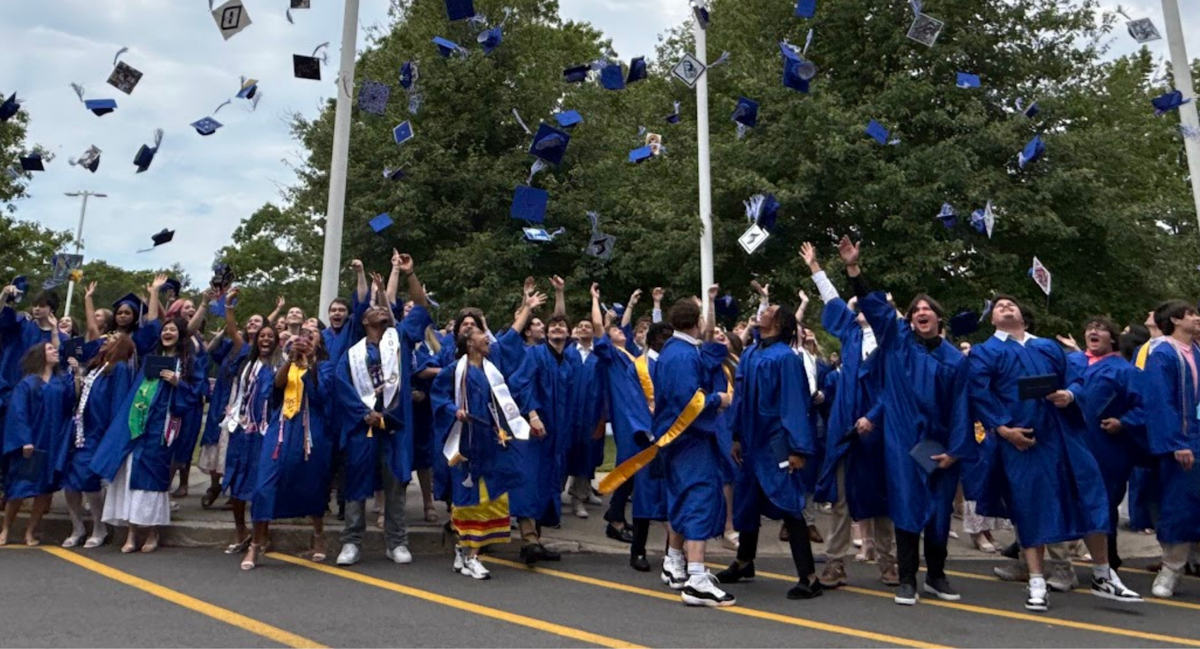Graduates throwing their caps