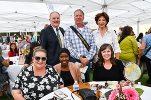 The Board of Trustees pose for a photo with DBHS retiree Steve Acciani and Tricia Acciani.