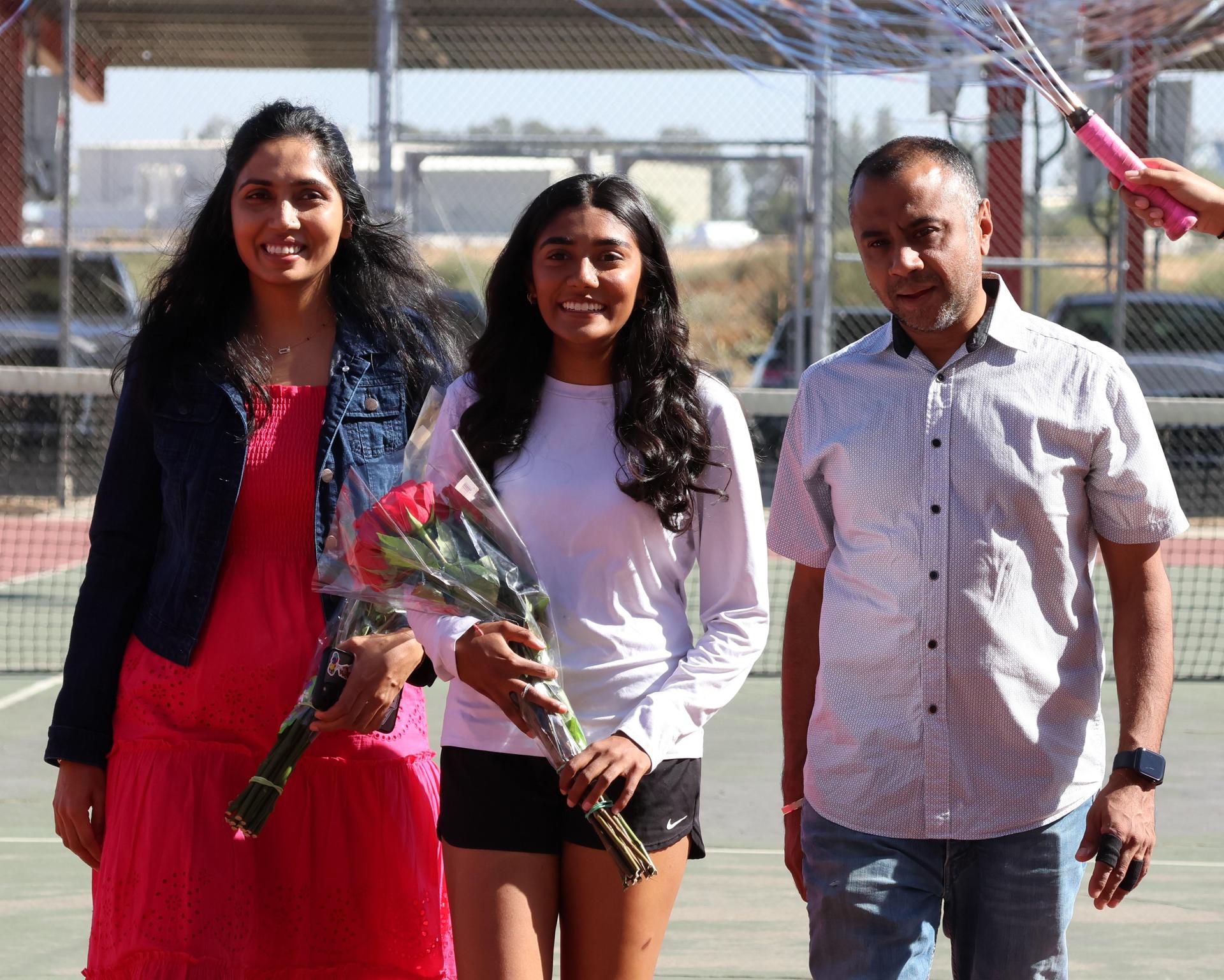 tennis players, family, and staff celebrating senior night