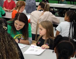 Buchanan Elementary students share writing with adults.