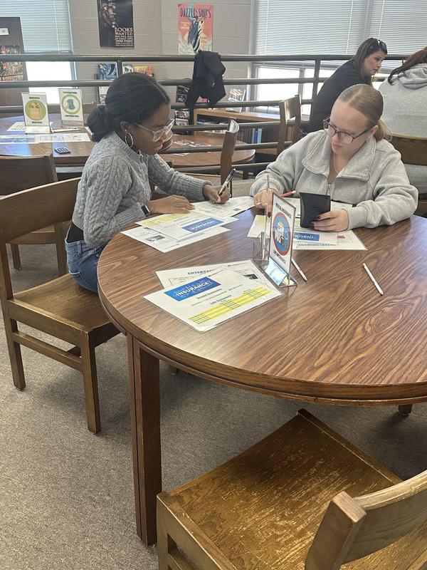Two girls working on their budget