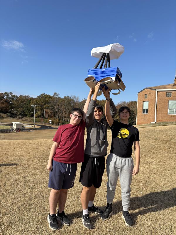 Students holding up their pinata