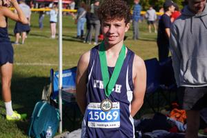 pic of a runner with a medal around his neck