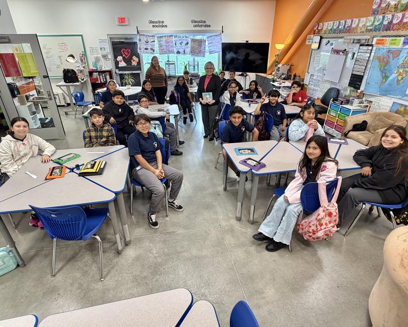 Students sit at desks in classroom