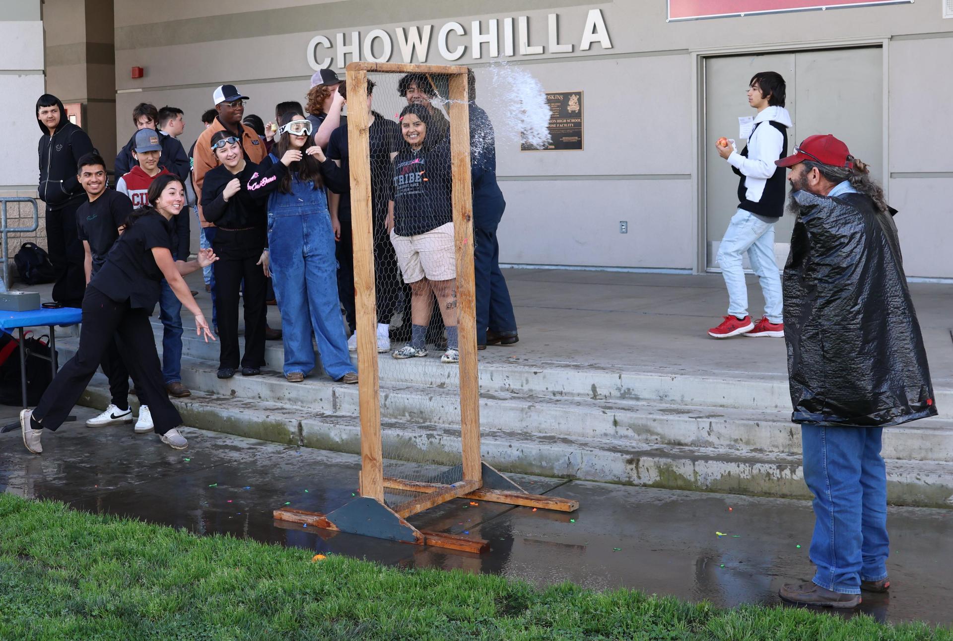 students and staff enjoying the water balloon toss