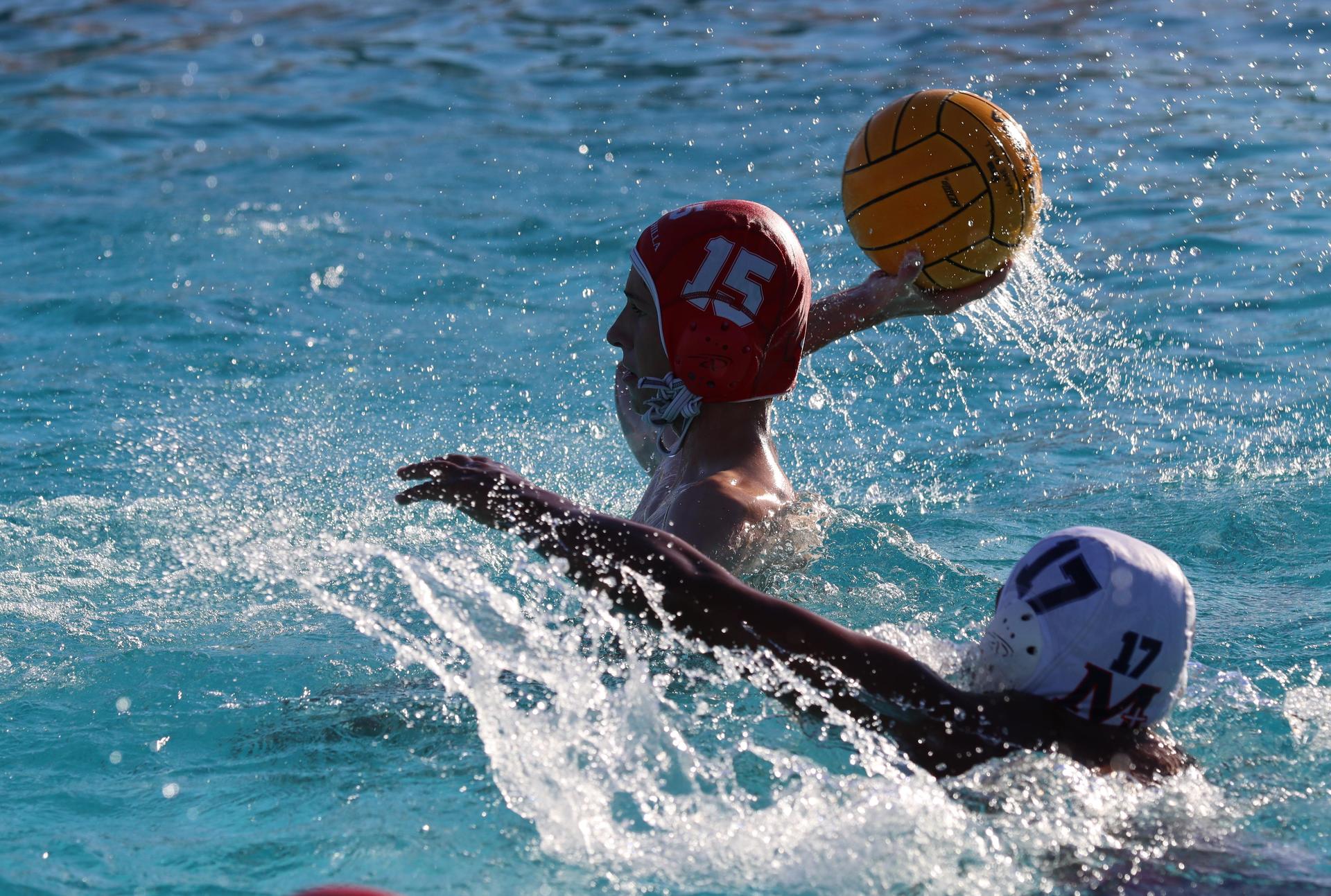 boys water polo players in action against san joaquin memorial