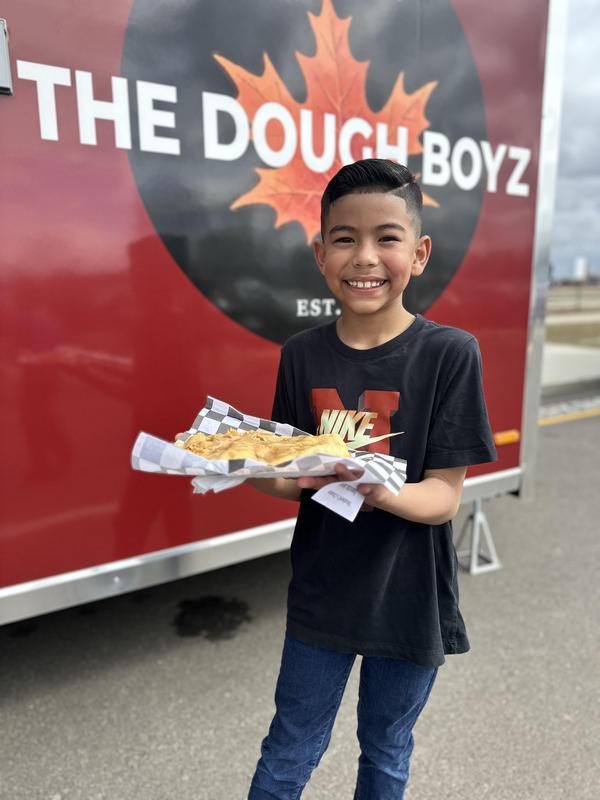 Student in front of a food truck.
