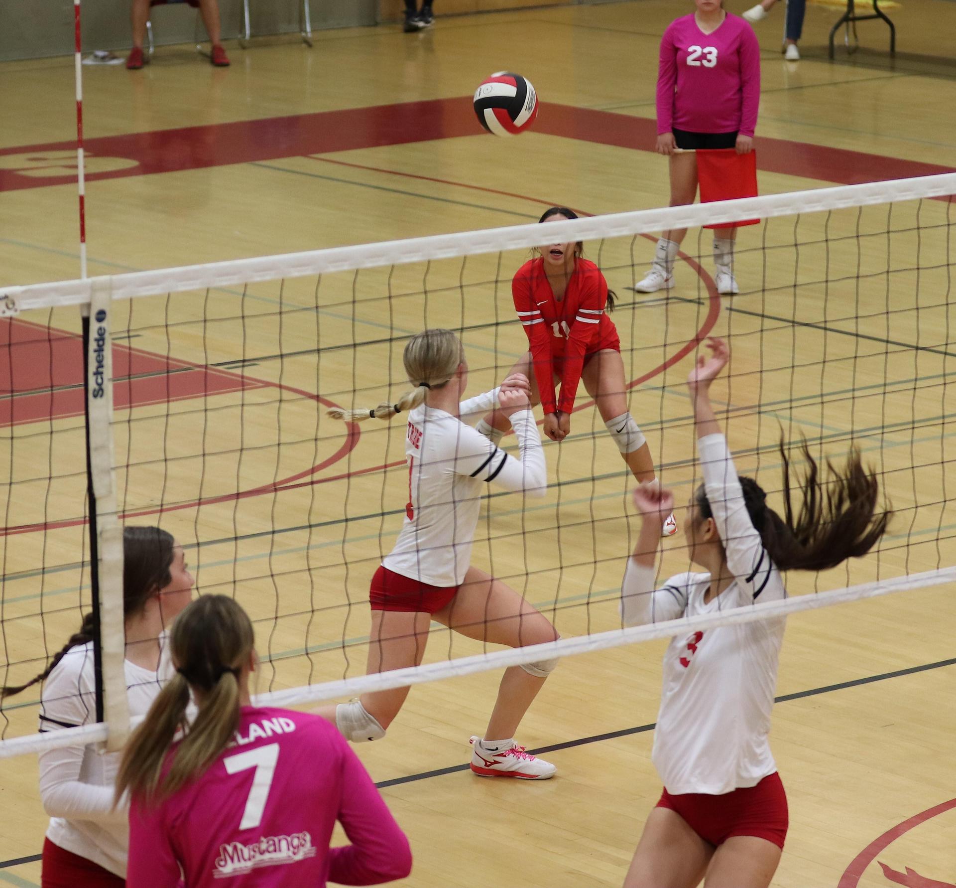 varsity volleyball players in action against Minarets