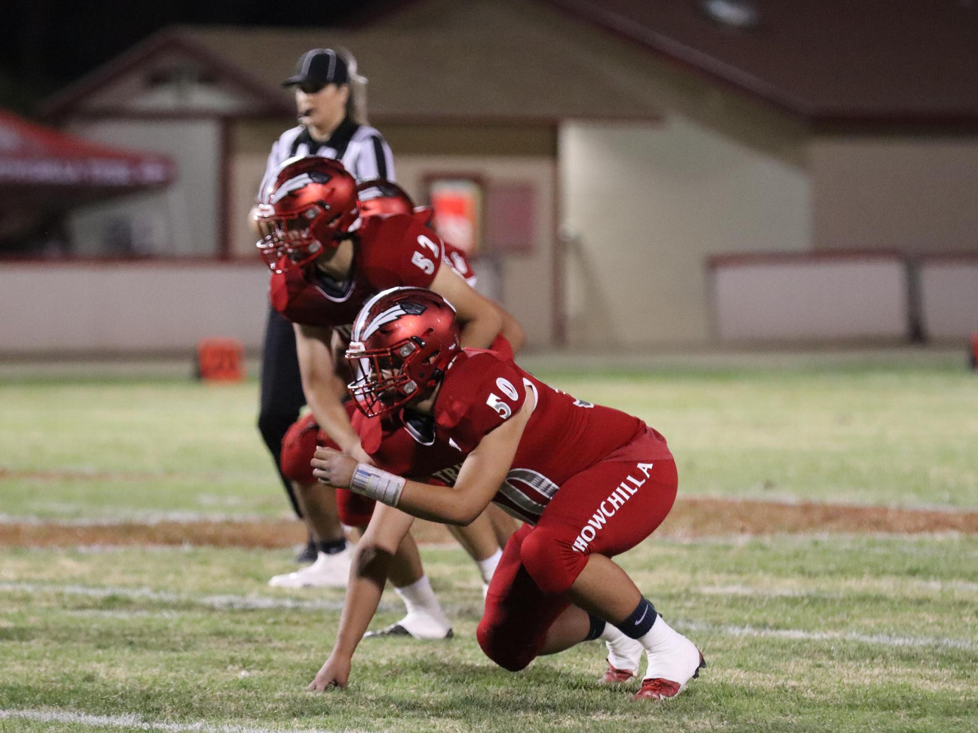 varsity football players in action against Riverdale