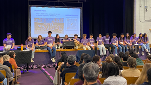 Upper Grades students answer questions from parents and students during an Open House session.