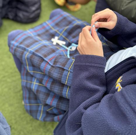 student holding rosary beads