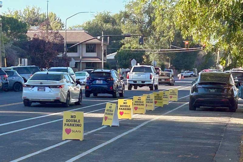 Cars inline to drop off students. No double parking signs are on street.