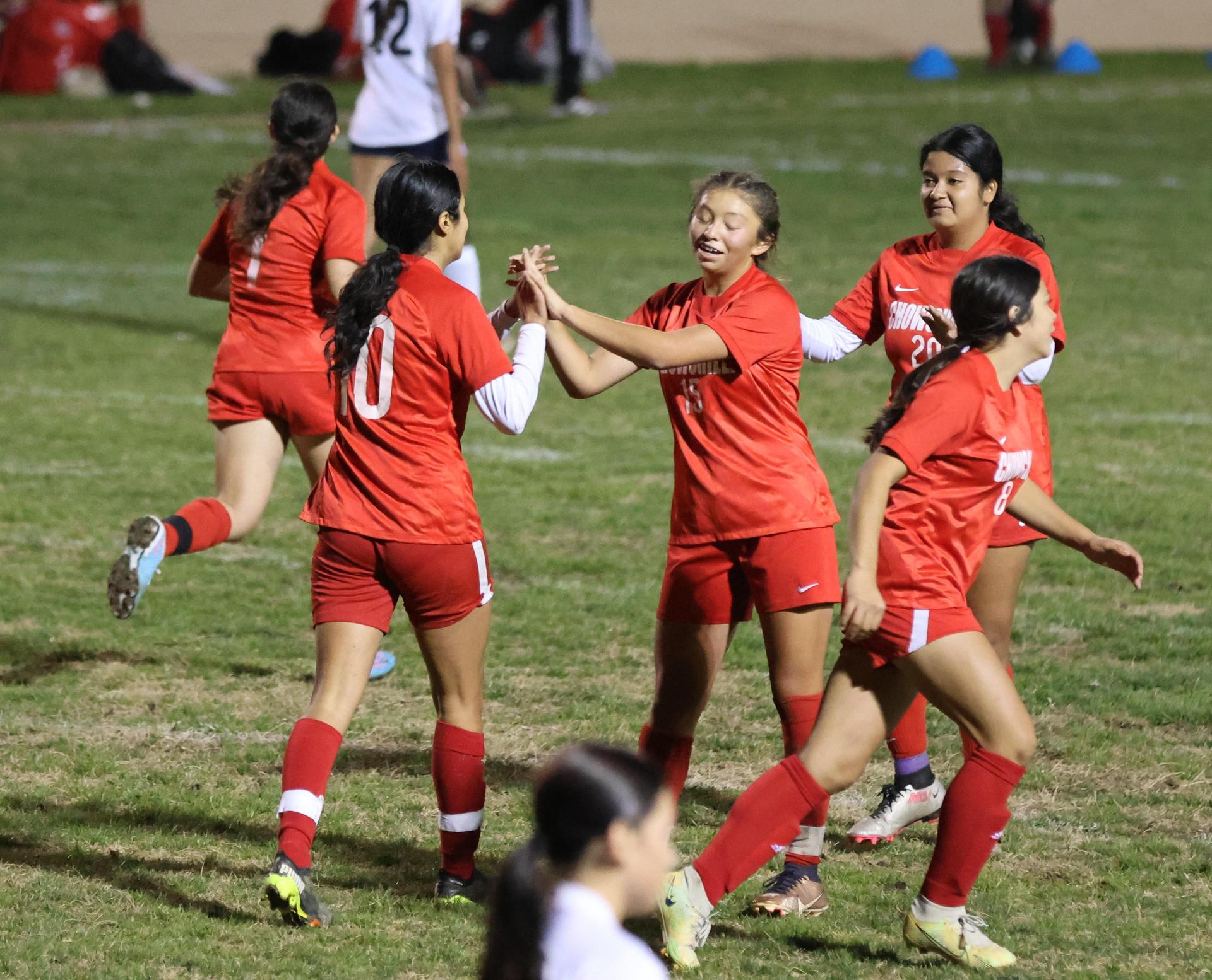 Varsity girls playing soccer against sunnyside