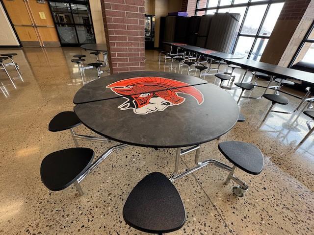 Cafeteria table with Trojan logo.