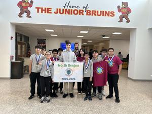 students holding up banner after geography bee