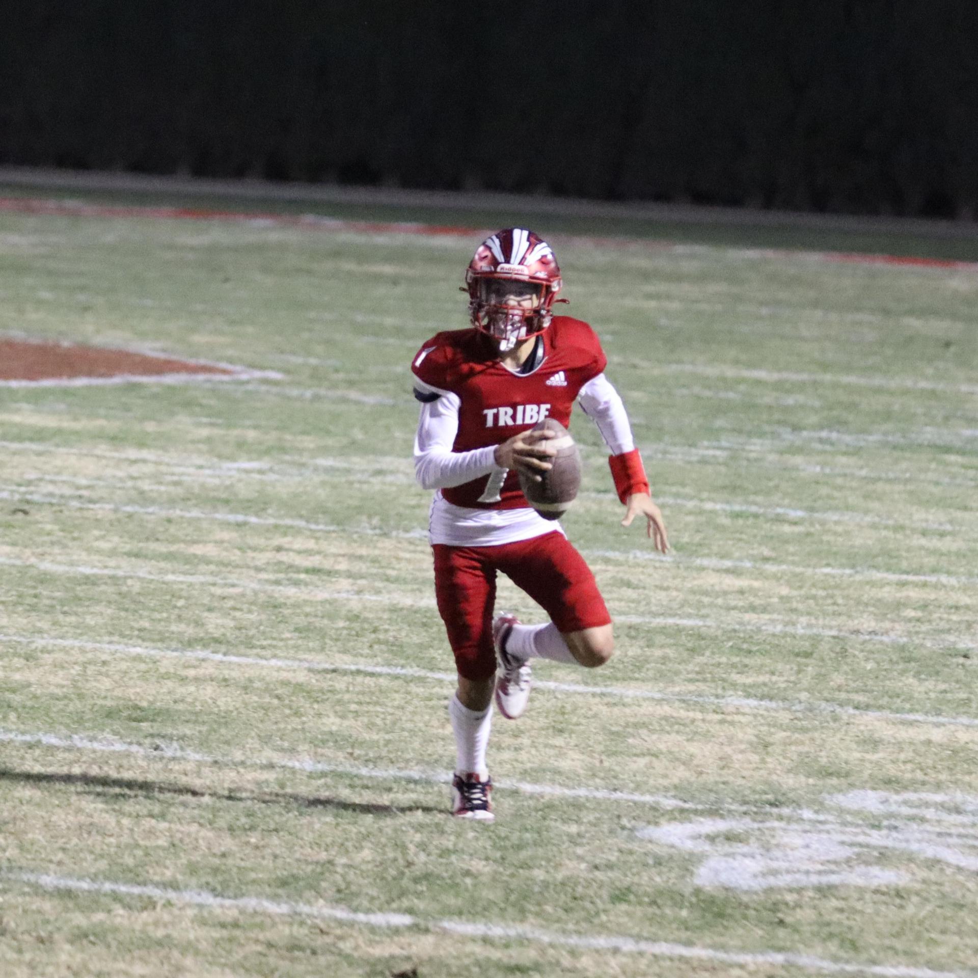varsity football players in action against Riverdale