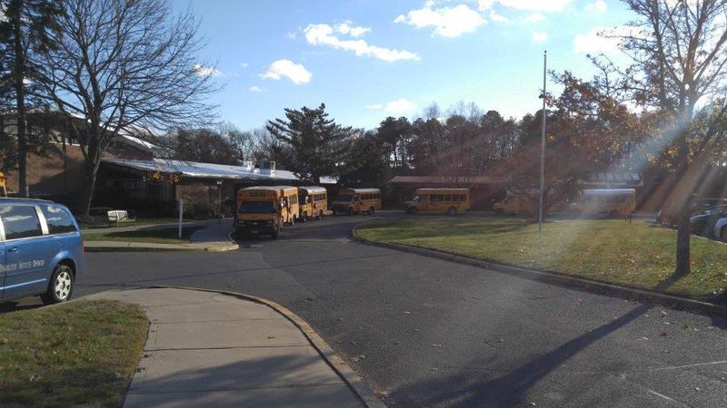 Picture of school building with buses in front