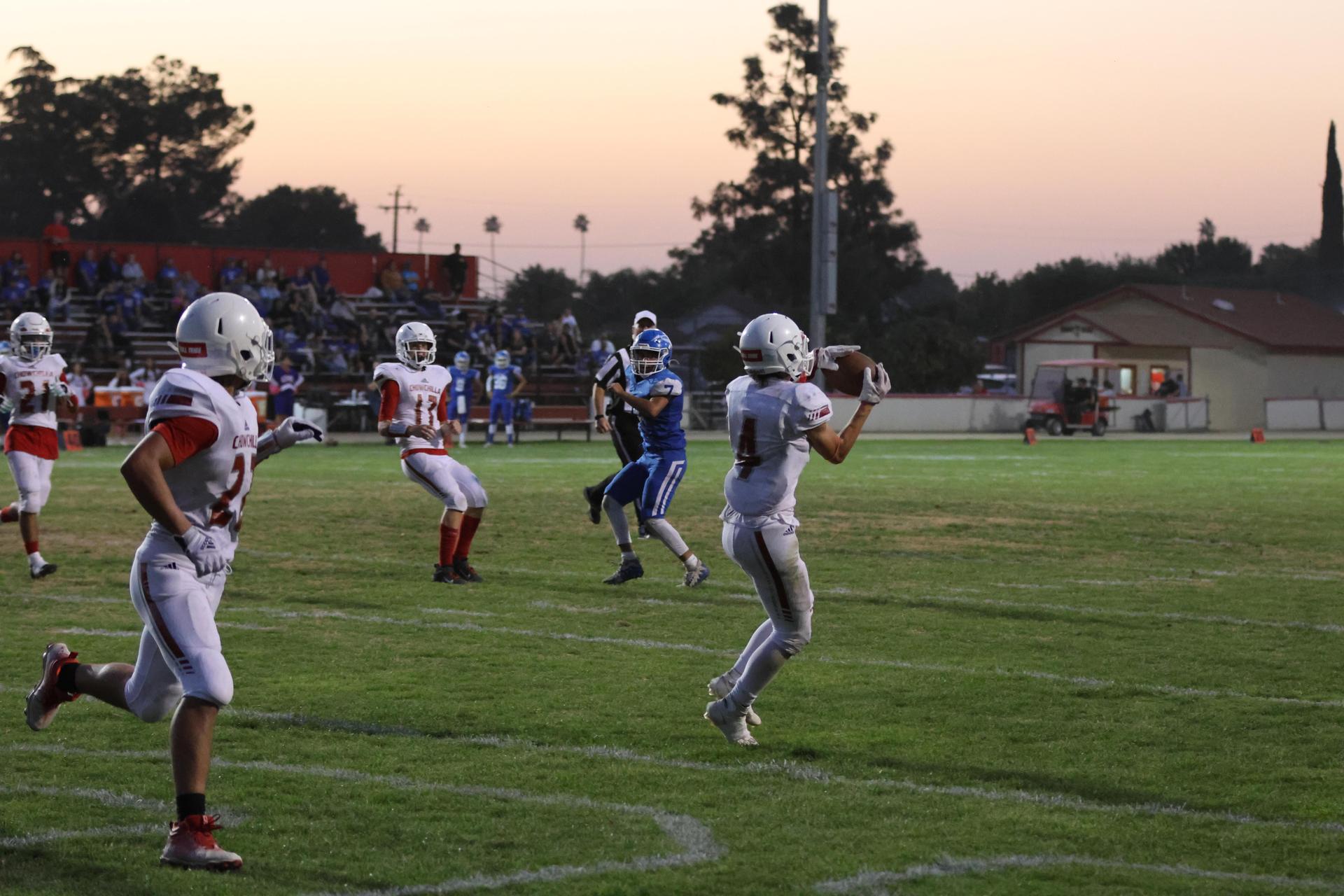Junior Varsity football players in action against Caruthers