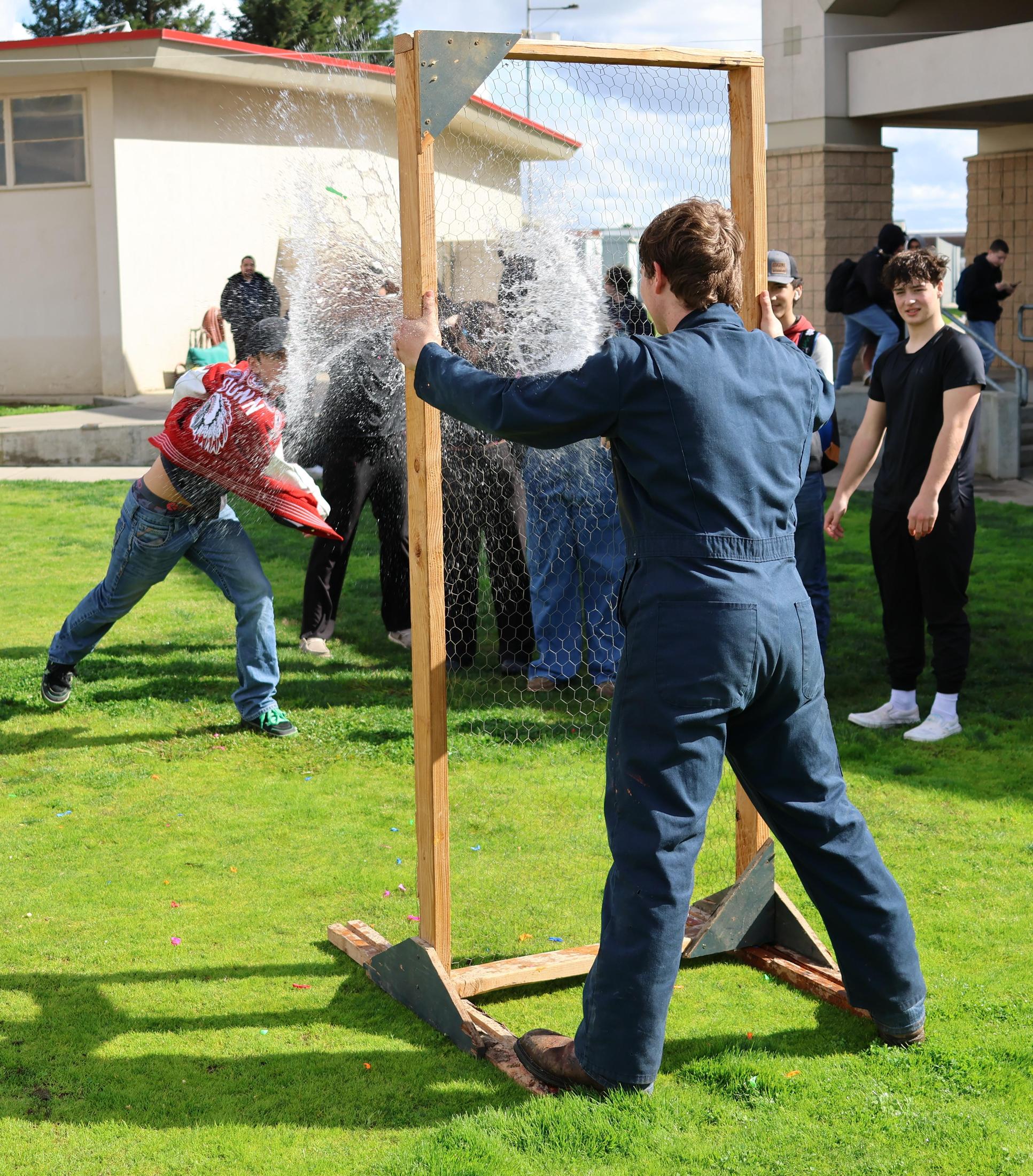students and staff enjoying the water balloon toss