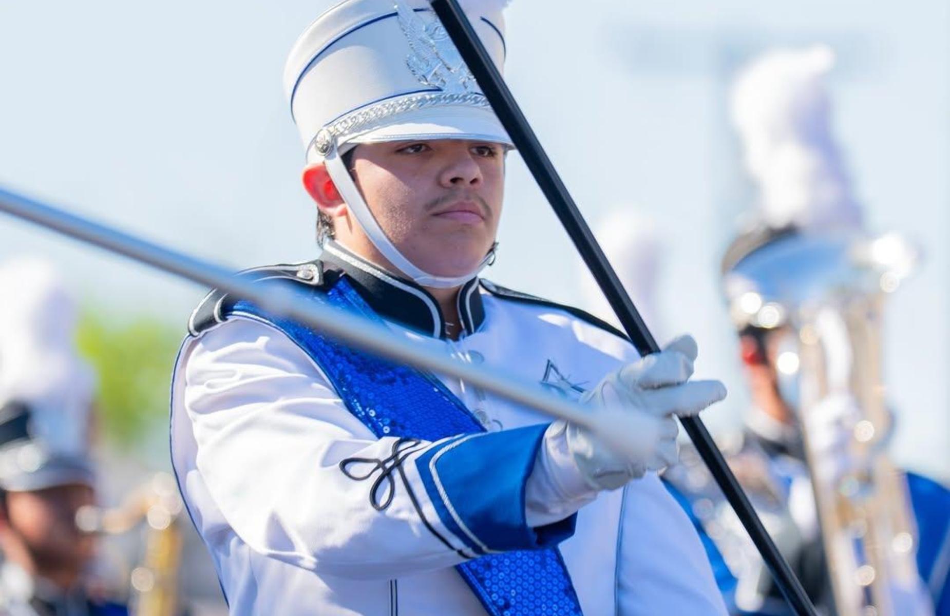 student in parade leads band