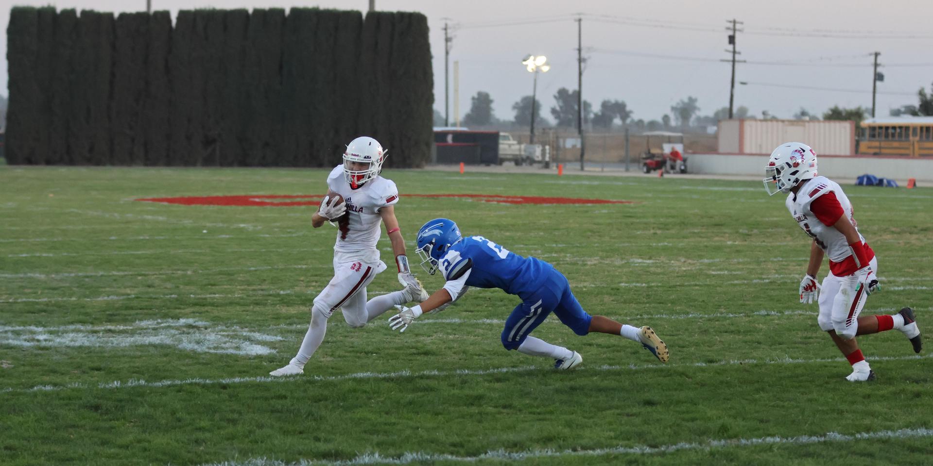 Junior Varsity football players in action against Caruthers
