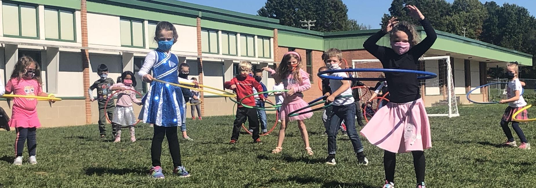 Students hula hoop in PE on the 50th day of school at MES