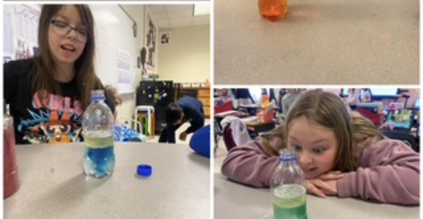 Children experimenting with colored liquids in bottles during a classroom activity.